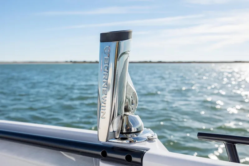 Slide: The Image of Axopar 29 CCX 2025 boat with a mounted rod holder on a sunny day. - 26