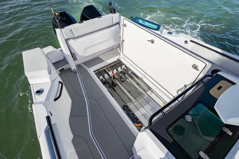 Slide: The Image of 2025 Axopar 29 CCX boat with open storage compartment on the water. - 31