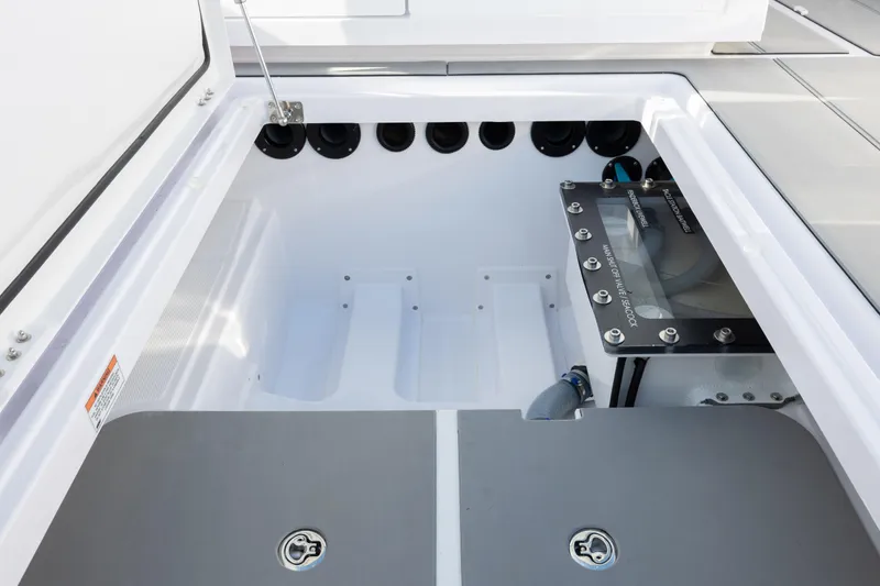 Slide: The Image of Axopar 29 CCX 2025 boat storage compartment with secure latches and organized layout. - 32