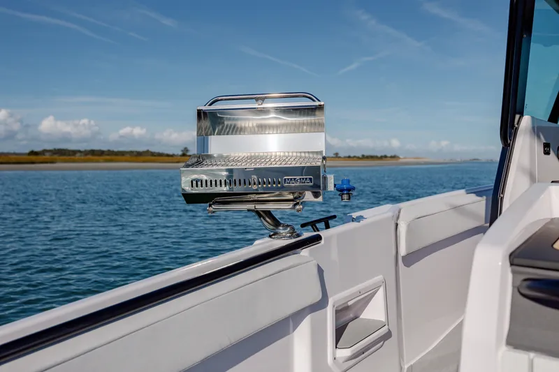 Slide: The Image of 2025 Axopar 29 CCX boat spotlight on calm water. - 33