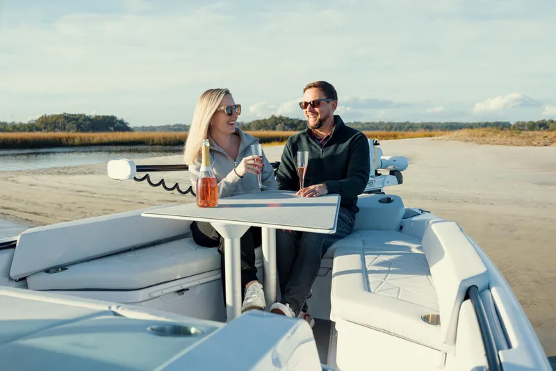 Slide: The Image of Couple enjoying drinks on 2025 Axopar 29 CCX boat, sunny day. - 45