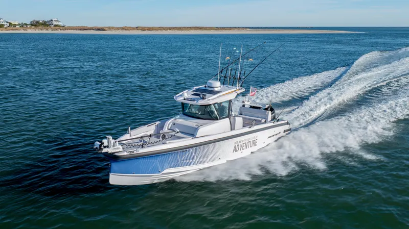 Slide: The Image of 2025 Axopar 29 CCX cruising on open water, showcasing sleek design and performance. - 7