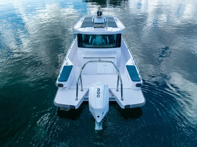 Slide: The Image of 2022 Axopar 28 boat on calm water, rear view with outboard motor. - 15