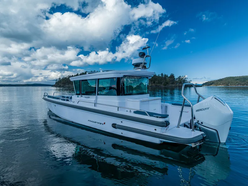 Slide: The Image of 2022 Axopar 28 boat on calm water under a cloudy sky. - 19