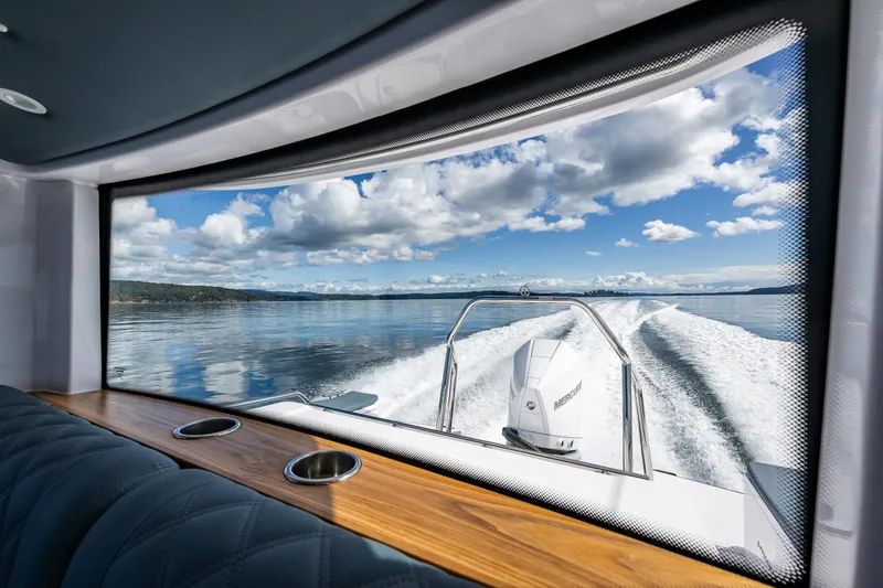 Slide: The Image of View from Axopar 28 boat, 2022 model, showcasing serene waters and blue sky. - 24