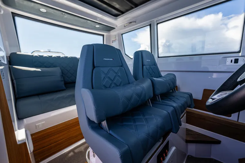 Slide: The Image of Interior of 2022 Axopar 28 boat with blue leather seating and modern design. - 33
