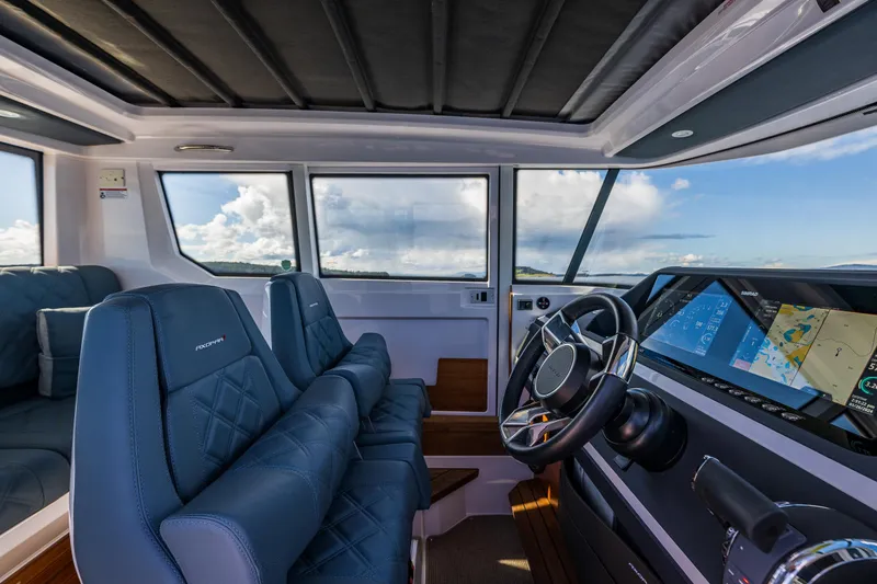 Slide: The Image of Interior of 2022 Axopar 28 boat with modern dashboard and seating. - 34