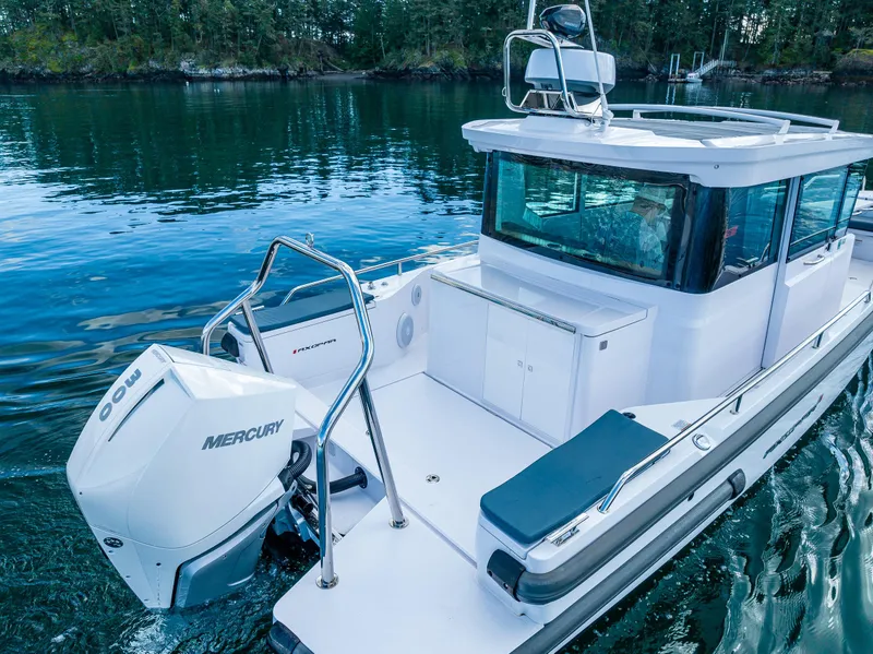 Slide: The Image of 2022 Axopar 28 boat with Mercury engine on calm water. - 8