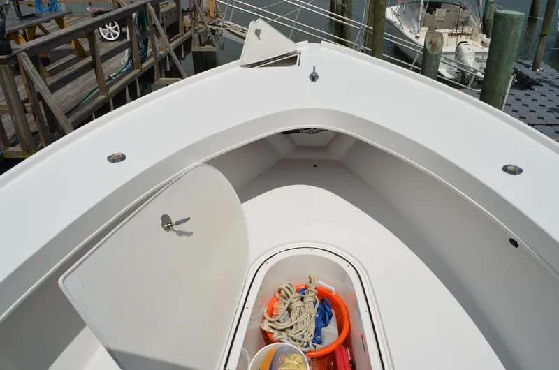 Slide: The Image of 2008 Jersey Cape 31 Little Devil boat deck with storage compartment open. - 10