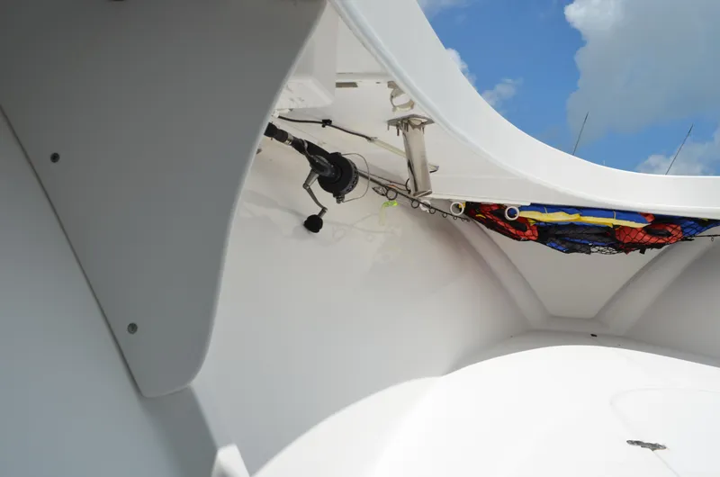 Slide: The Image of 2008 Jersey Cape 31 Little Devil boat interior with fishing gear and blue sky. - 11
