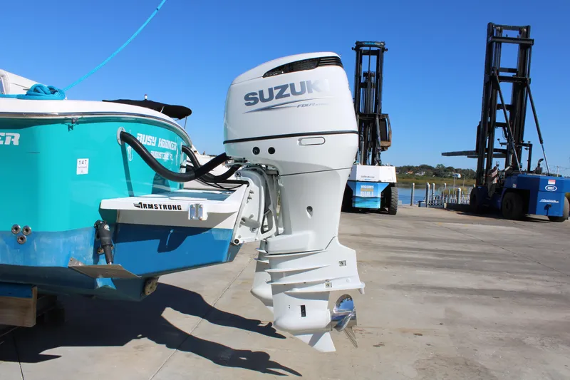 Slide: The Image of 2008 Jersey Cape 31 Little Devil boat with Suzuki outboard motor on a dock. - 2