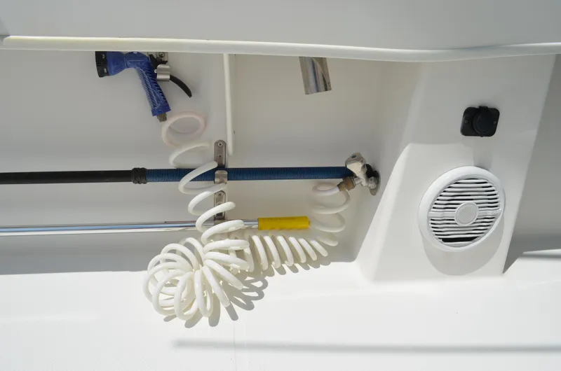 Slide: The Image of 2008 Jersey Cape 31 Little Devil boat interior with coiled hose and speaker. - 21