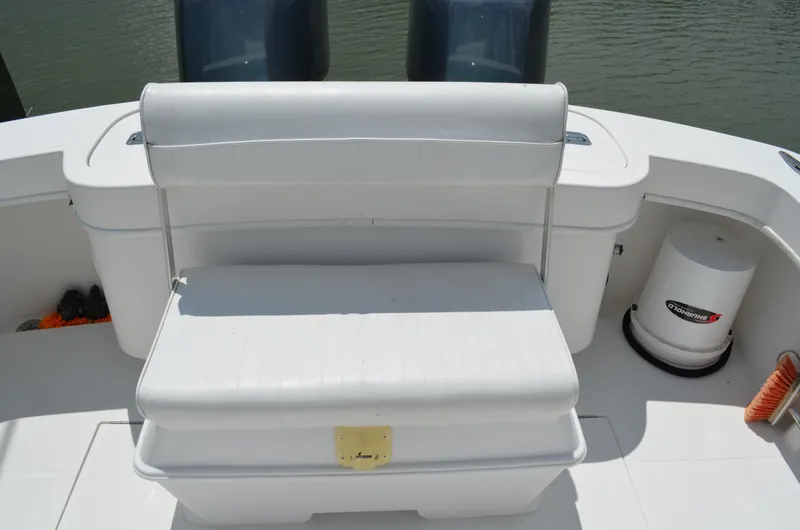 Slide: The Image of 2008 Jersey Cape 31 Little Devil boat seating area with storage and twin engines. - 22