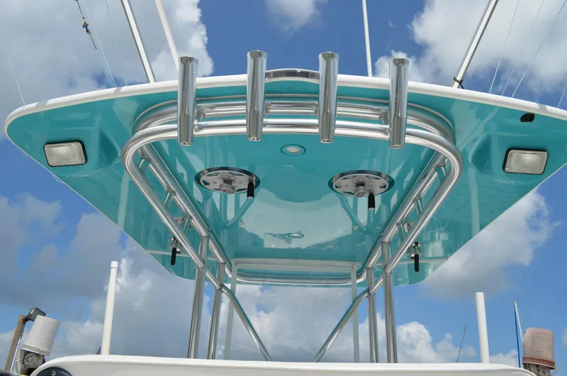 Slide: The Image of 2008 Jersey Cape 31 Little Devil boat with turquoise T-top against a cloudy sky. - 26