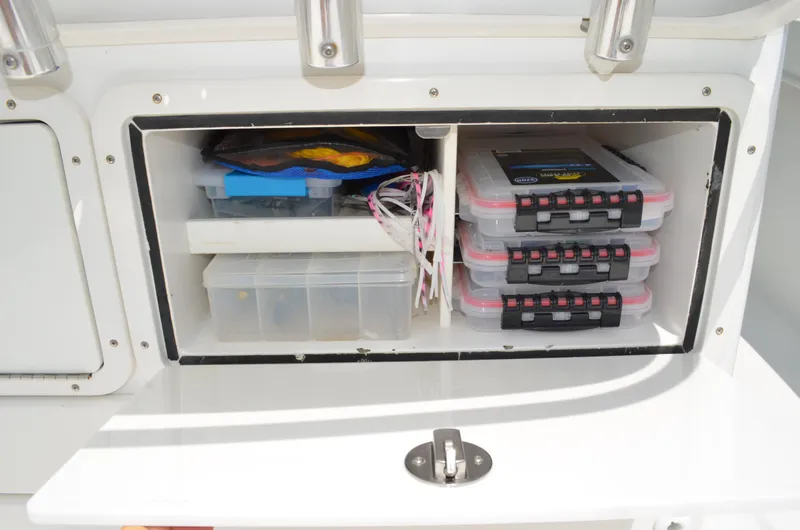 Slide: The Image of Storage compartment on 2008 Jersey Cape 31 Little Devil, organized with tackle boxes and fishing gear. - 28