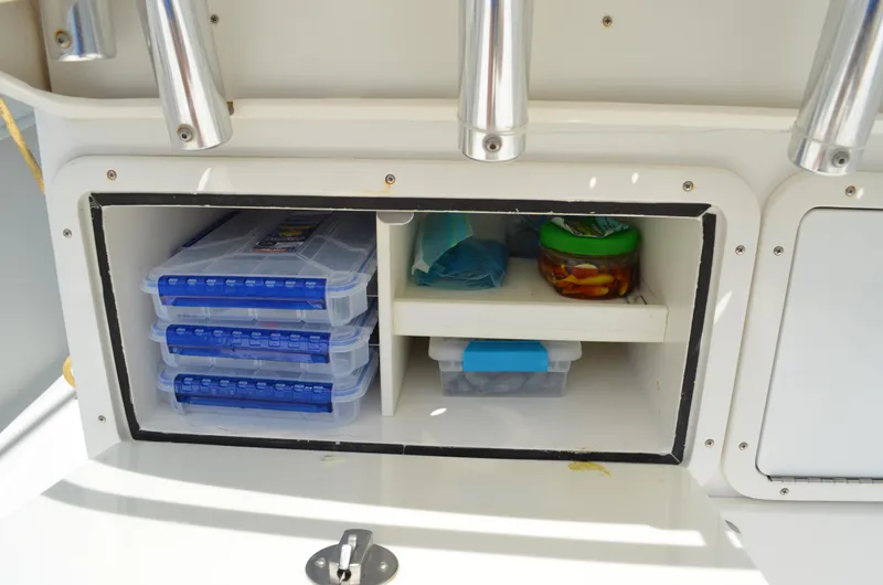 Slide: The Image of Storage compartment on 2008 Jersey Cape 31 Little Devil boat with organized tackle boxes. - 29