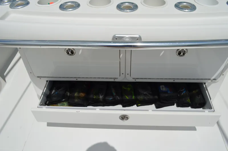 Slide: The Image of 2008 Jersey Cape 31 Little Devil boat storage compartment with fishing gear. - 30