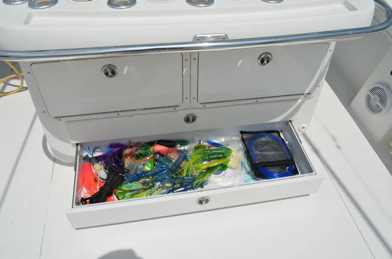 Slide: The Image of Open tackle storage on 2008 Jersey Cape 31 Little Devil boat with colorful fishing lures. - 31