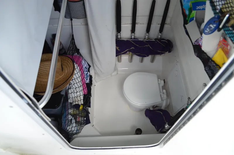 Slide: The Image of 2008 Jersey Cape 31 Little Devil boat bathroom with storage nets and toilet. - 44
