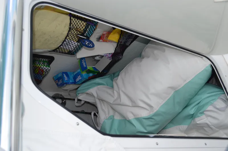 Slide: The Image of Storage compartment in 2008 Jersey Cape 31 Little Devil boat with supplies and bedding. - 6
