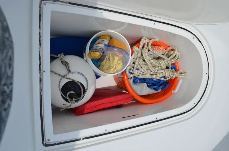 Slide: The Image of Storage compartment on 2008 Jersey Cape 31 Little Devil with boating gear and supplies. - 7