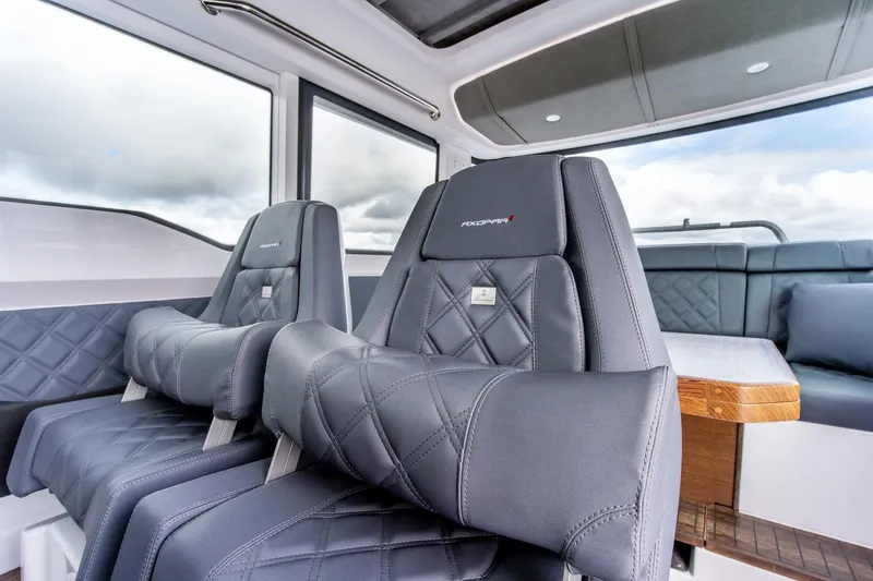 Slide: The Image of Luxurious interior of 2021 Axopar 37 XC with plush seating and modern design. - 11