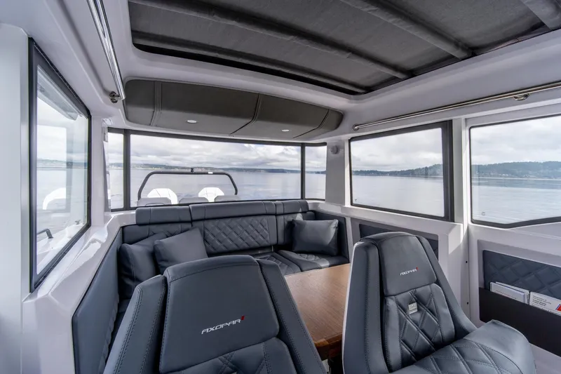 Slide: The Image of Luxurious interior of 2021 Axopar 37 XC boat with panoramic windows and plush seating. - 12