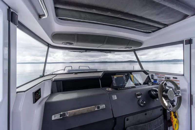 Slide: The Image of Interior view of 2021 Axopar 37 XC boat cockpit with modern controls. - 13