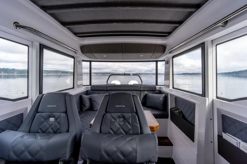 Slide: The Image of Interior of 2021 Axopar 37 XC boat with luxurious seating and panoramic windows. - 14
