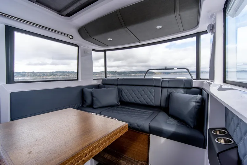 Slide: The Image of Luxurious interior of 2021 Axopar 37 XC boat with plush seating and wooden table. - 16