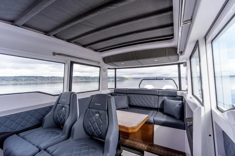 Slide: The Image of Interior of 2021 Axopar 37 XC boat with luxurious seating and panoramic windows. - 17
