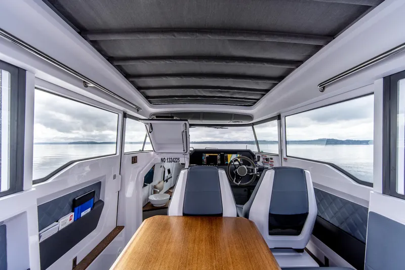 Slide: The Image of Interior of 2021 Axopar 37 XC boat with modern seating and steering wheel. - 18