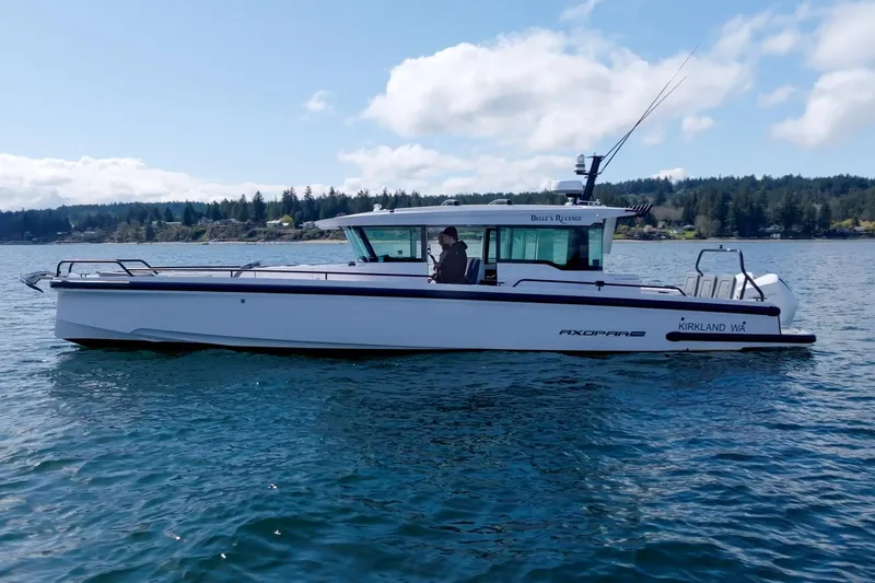 Slide: The Image of 2021 Axopar 37 XC boat on calm water with scenic background. - 2