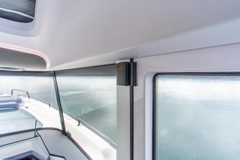 Slide: The Image of Interior view of 2021 Axopar 37 XC boat window and cabin details. - 26