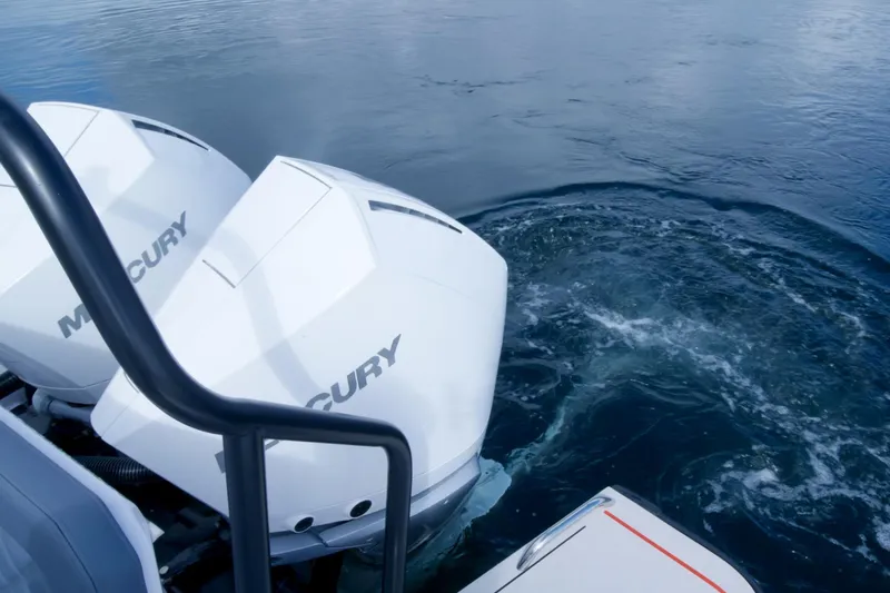 Slide: The Image of Twin Mercury outboard engines on 2021 Axopar 37 XC boat in water. - 31