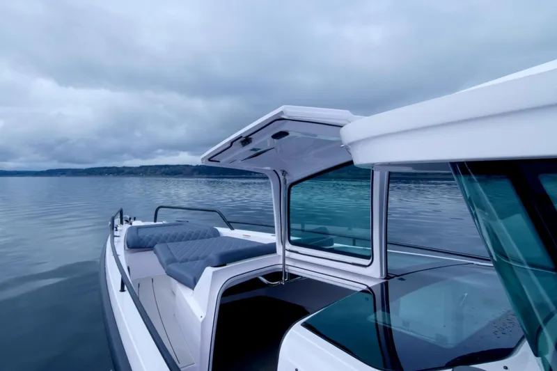 Slide: The Image of Axopar 37 XC 2021 boat on calm water under cloudy sky. - 32