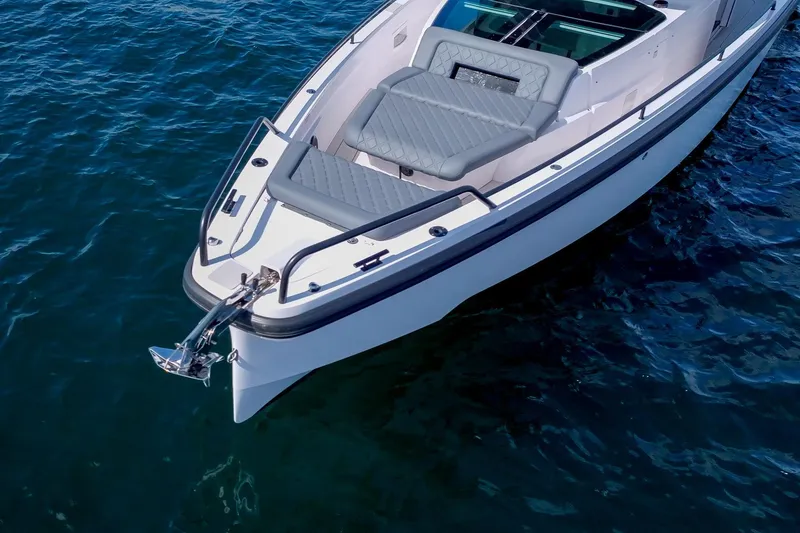 Slide: The Image of Axopar 37 XC 2021 boat with sleek design on calm water. - 38