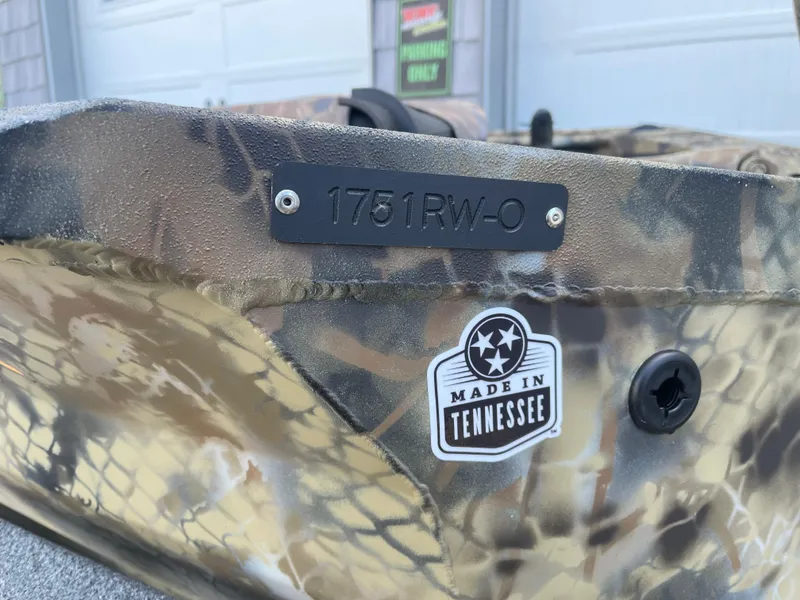 Slide: The Image of 2025 Excel 1751 River Warrior boat with camouflage design, "Made in Tennessee" sticker. - 11