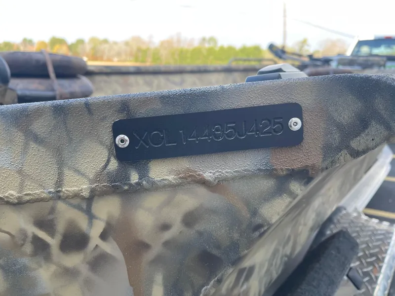Slide: The Image of 2025 Excel 1751 River Warrior boat with camouflage pattern and visible serial number plate. - 14