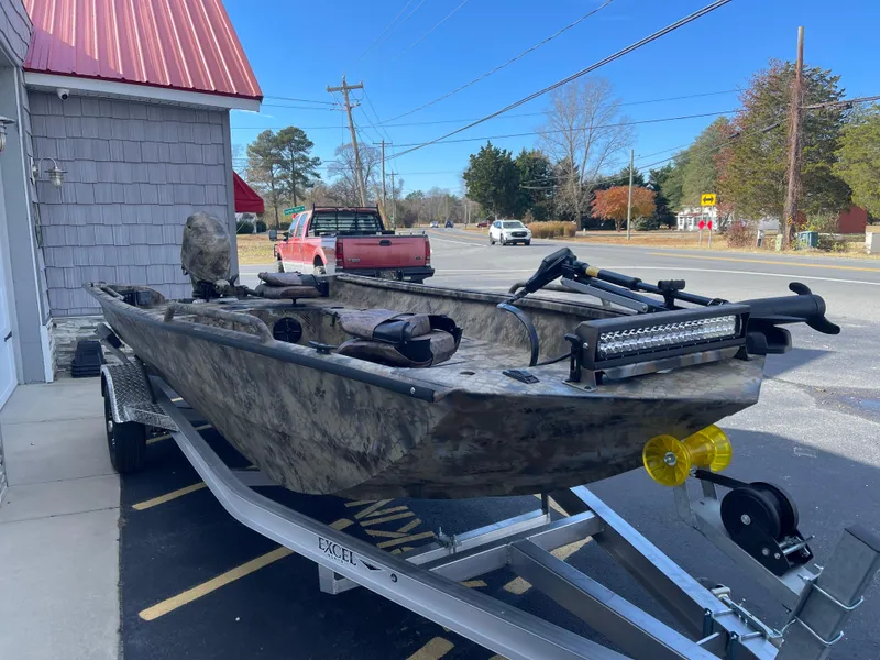 Slide: The Image of 2025 Excel 1751 River Warrior boat on trailer, parked outside. - 4