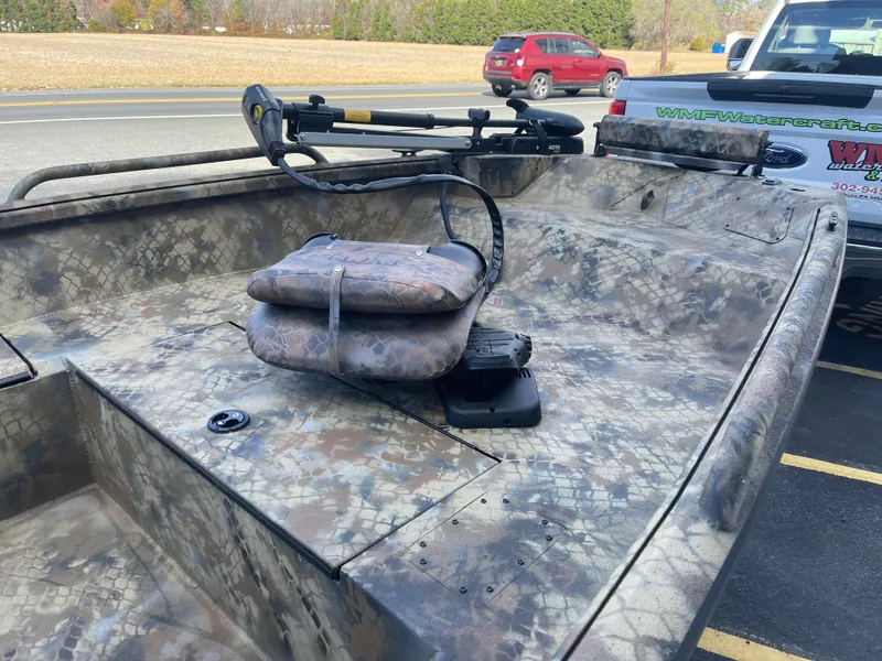 Slide: The Image of 2025 Excel 1751 River Warrior boat with camouflage design and seating. - 5