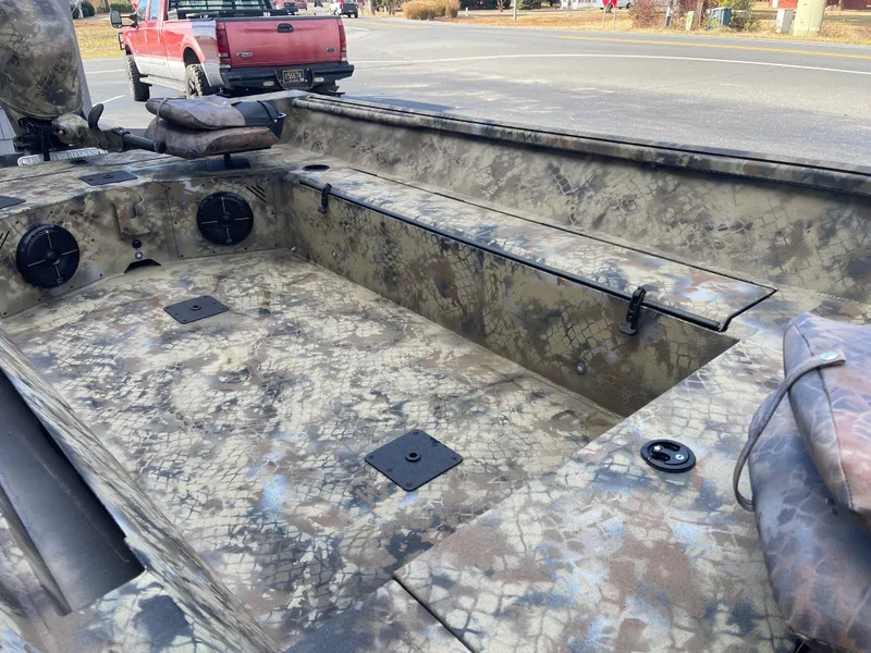 Slide: The Image of 2025 Excel 1751 River Warrior boat interior with camouflage design and seating. - 6