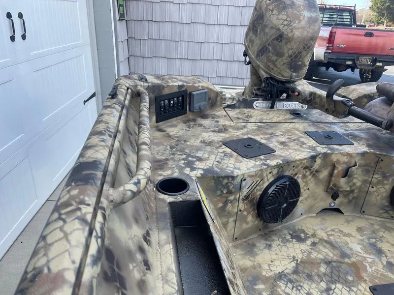 Slide: The Image of 2025 Excel 1751 River Warrior boat with camouflage design and control panel. - 8