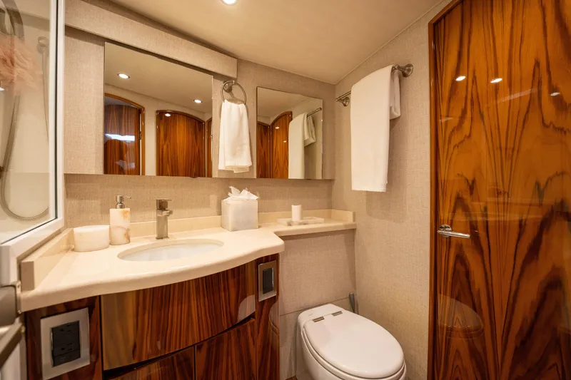 Slide: The Image of Luxurious bathroom in 2022 Viking 54 Convertible yacht with wood accents and modern fixtures. - 21