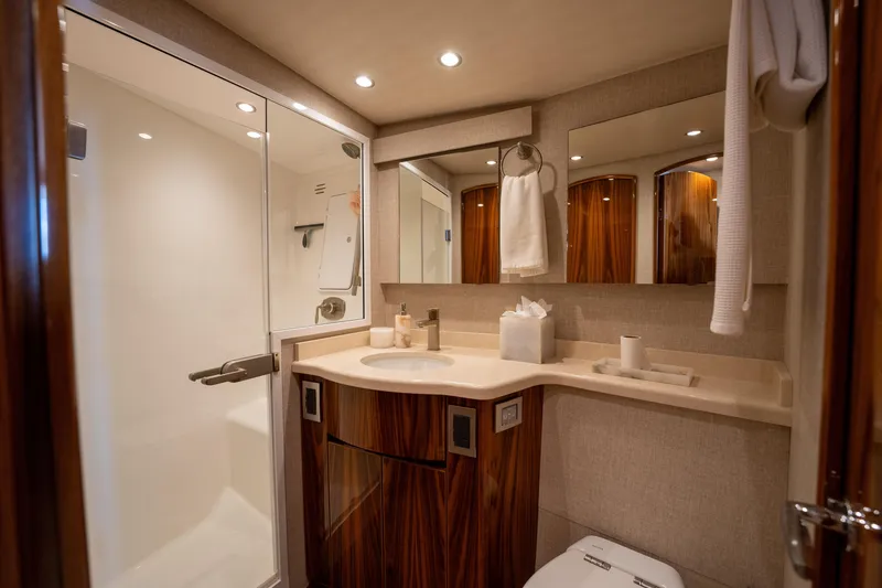 Slide: The Image of Luxurious bathroom in 2022 Viking 54 Convertible yacht with modern fixtures and elegant wood accents. - 27