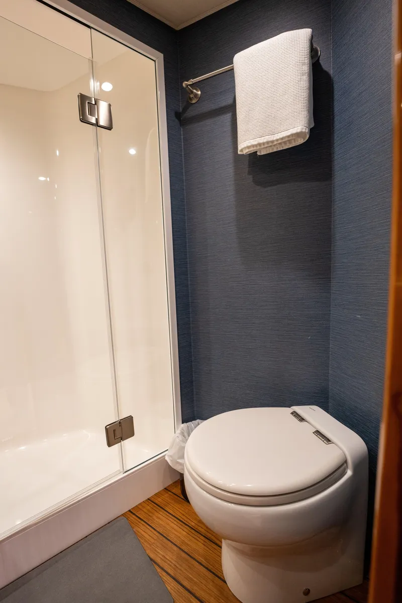 Slide: The Image of Modern bathroom in 2022 Viking 54 Convertible yacht with shower and toilet. - 31