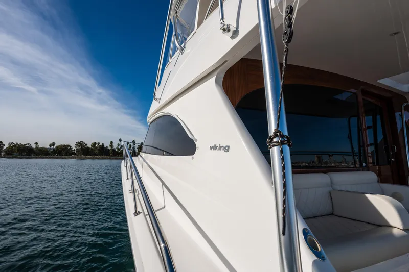 Slide: The Image of Steering wheel of 2022 Viking 54 Convertible yacht on calm water. - 37