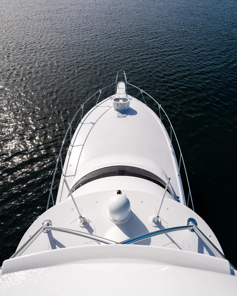 Slide: The Image of Aerial view of 2022 Viking 54 Convertible yacht on calm water. - 38