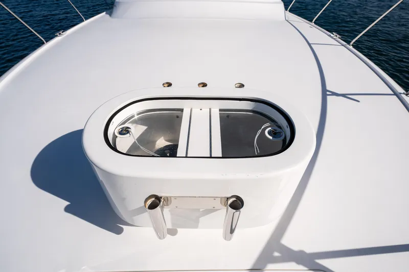 Slide: The Image of Viking 54 Convertible 2022 yacht deck with teak flooring, surrounded by water. - 40