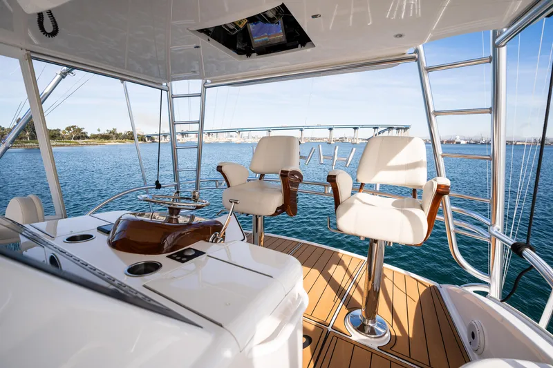 Slide: The Image of 2022 Viking 54 Convertible yacht helm with ocean view and luxurious seating. - 42